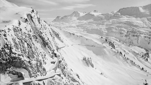 In this picture you can see the Arlberg pass road full of snow from earlier times (black and white)