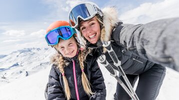 Mother and daughter skiing in Warth-Schröcken region