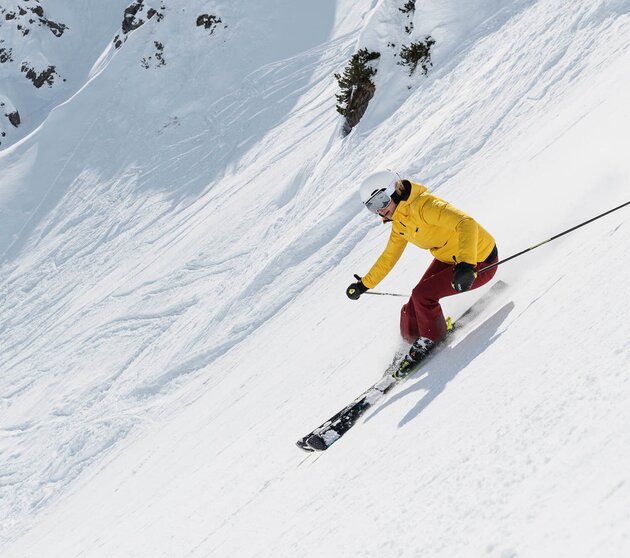 Female skier on one of the steepest groomed ski slopes in the world